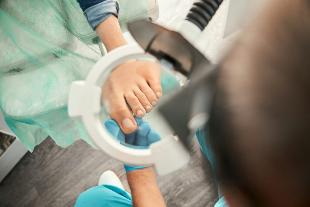 Attentive medical worker looking through magnifying glass