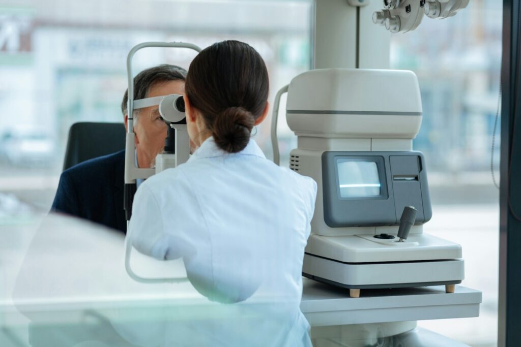 Nice dark haired woman using the optical instrument