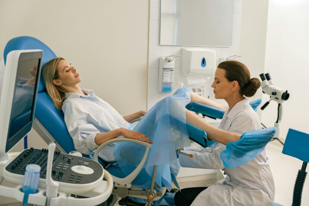 Young woman on appointment with her gynecologist during regular visit to women's consultation